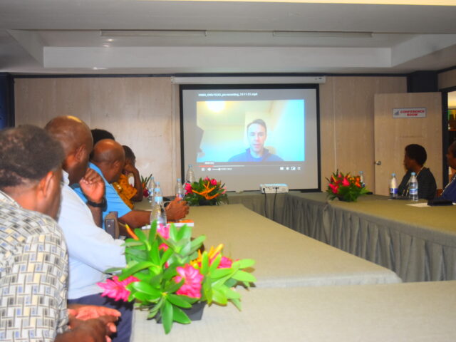 Delegates in Vanuatu watching an address from Joe Crispell, Data Scientist at the FCDO hub.