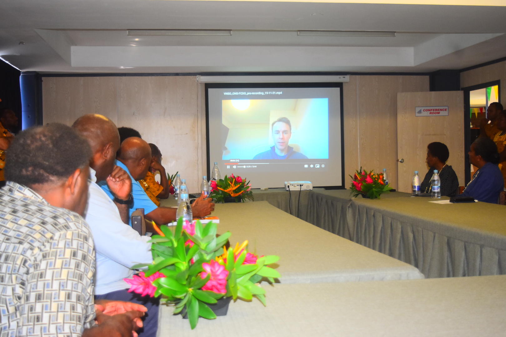 Delegates in Vanuatu watching an address from Joe Crispell, Data Scientist at the FCDO hub.